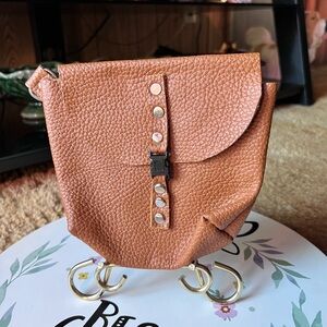 Genuine leather handmade pouch with metal loop for adding to belt.